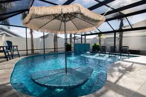 Indoor Hotel Or Spa Lap Pool With White Tile, Underwater Lighting, Stainless Steel Handrail, And An Integrated, Illuminated Whirlpool Spa