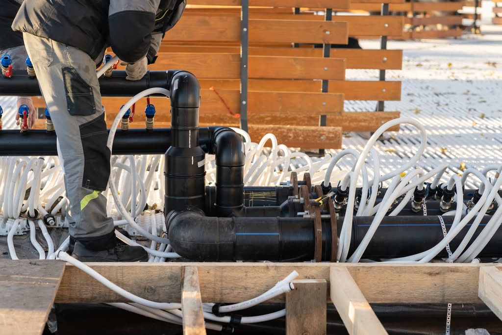 How to Choose an Ocala Pool Builder (2026 Expert Guide) 2 A Professional Plumber Installing A Complex Pvc Pipe Manifold For A Custom Concrete Swimming Pool In Las Vegas, Nv, Ensuring Proper Water Flow.