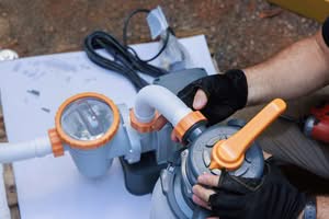 Close-Up Of A Technician'S Hands Wearing Black And Yellow Gloves Assembling Grey And Orange Hoses On A Pool Filter System, Demonstrating Professional Variable-Speed Pool Pump Upgrades In Phoenix, Az.