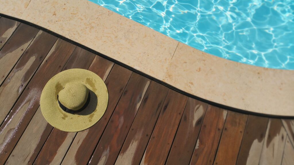 Choosing Custom Pool Deck Finishes in Florida: 2026 Homeowner's Guide 1 Custom Pool Deck Finishes Florida Showing Textured Knockdown Coating Around Inground Pool