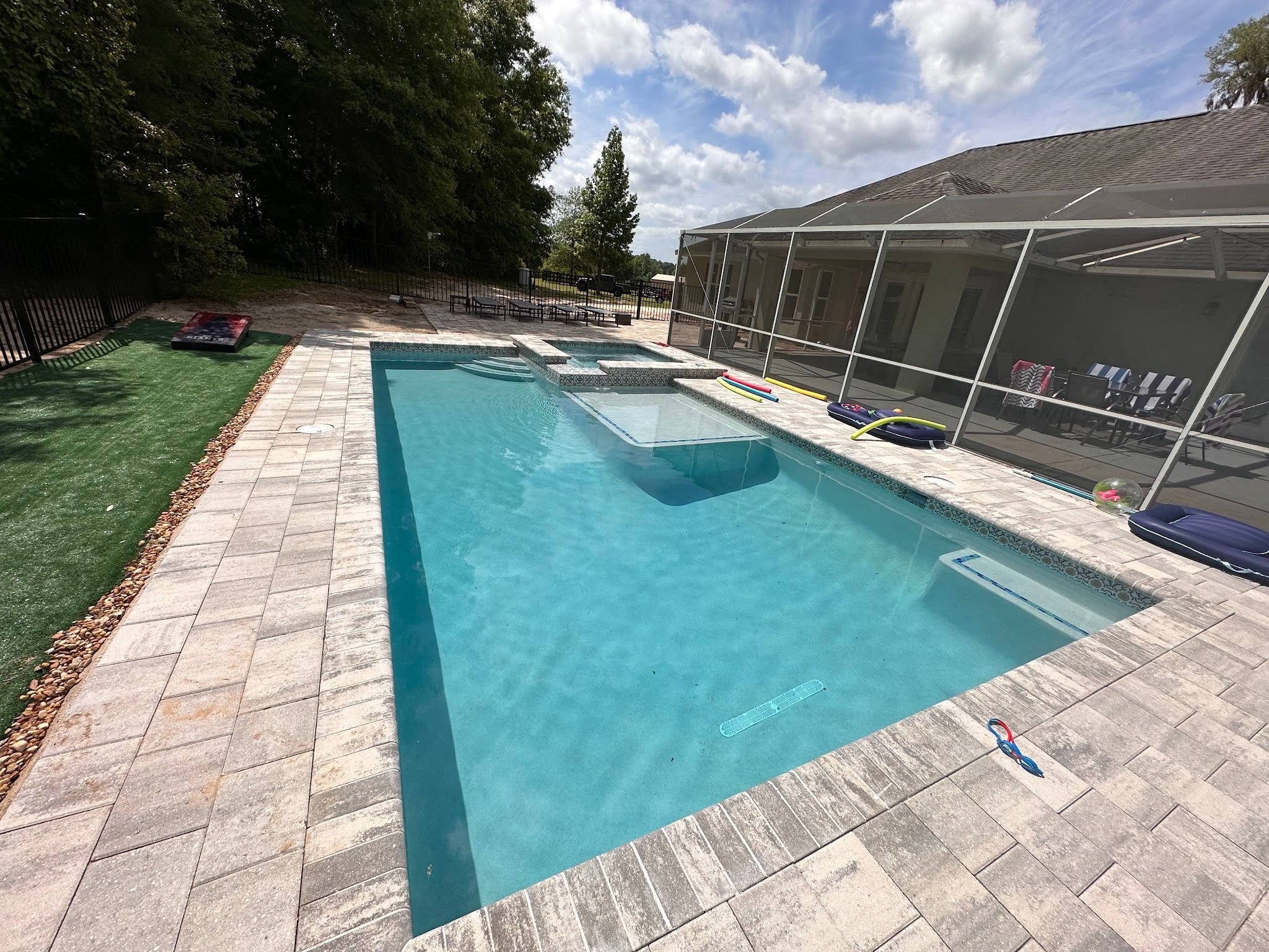 Technician Performing An Algae Removal Pool Service On A Cloudy Green Backyard Pool In Ocala